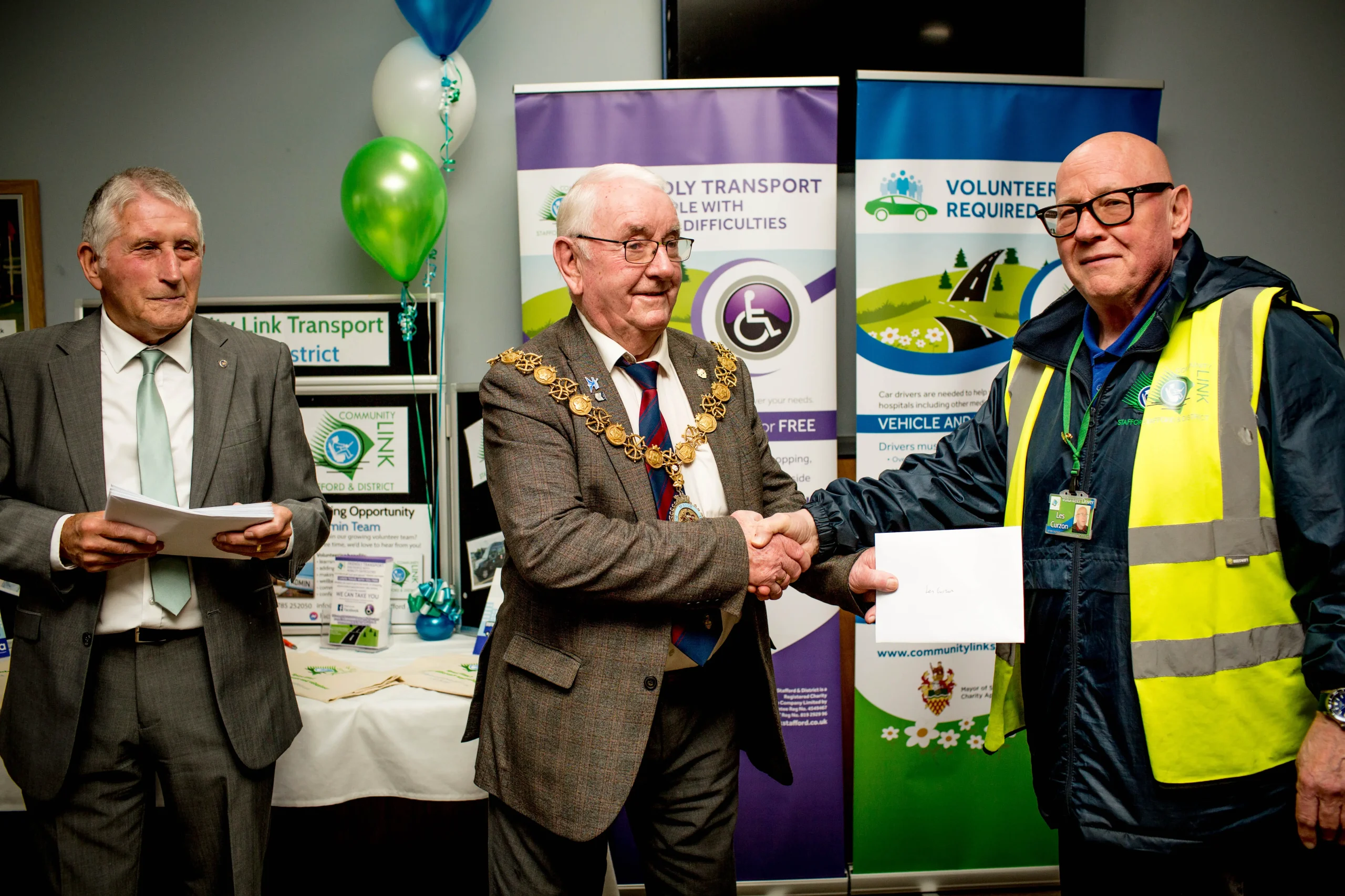 A Community Link volunteer receiving recognition at a community event